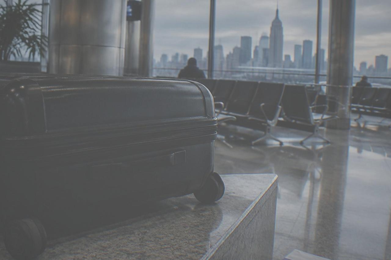 LaGuardia Airport terminal interior with empty seating and luggage carts