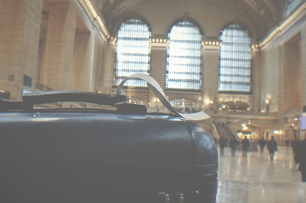 Train hall interior with high ceilings, a departure board and wide open floor space