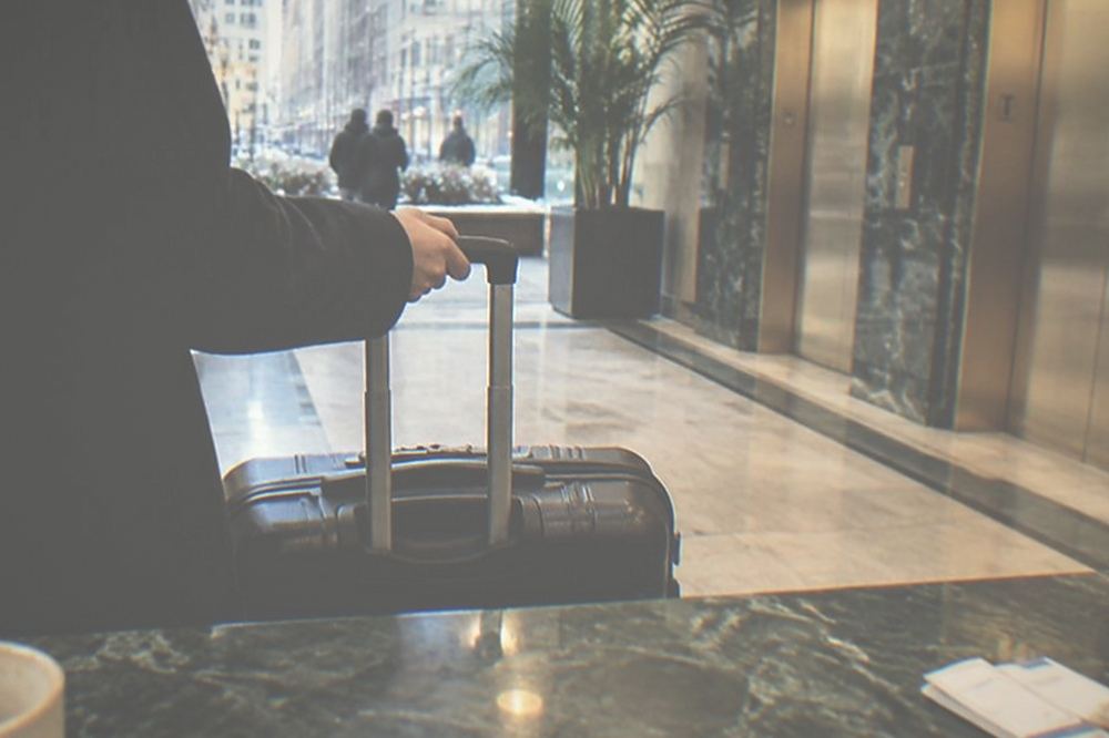 Luggage held behind a hotel front desk counter