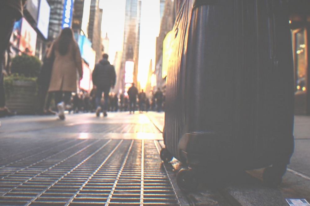 Sidewalk outside a theatre with people walking past before a show