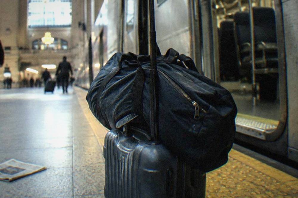 A commuter rail platform with a train waiting at the station and open doors