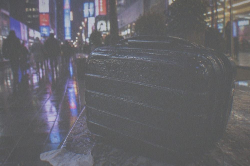 Evening street corner in Manhattan with lit storefronts after dark
